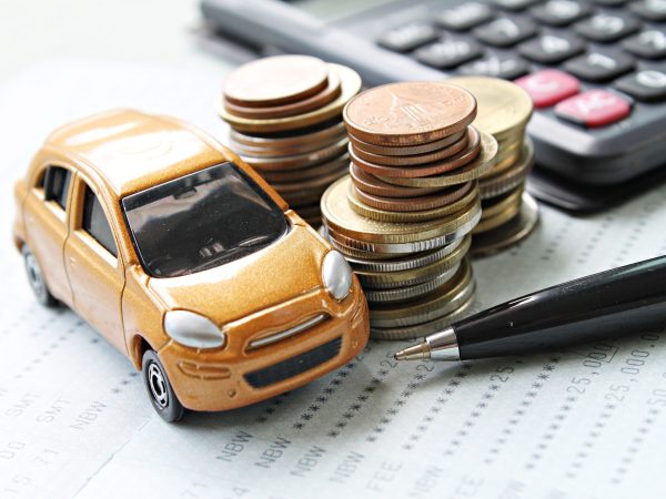 88327269 - business, finance, saving money or car loan concept : miniature car model, coins stack, calculator and saving account book or financial statement on desk table